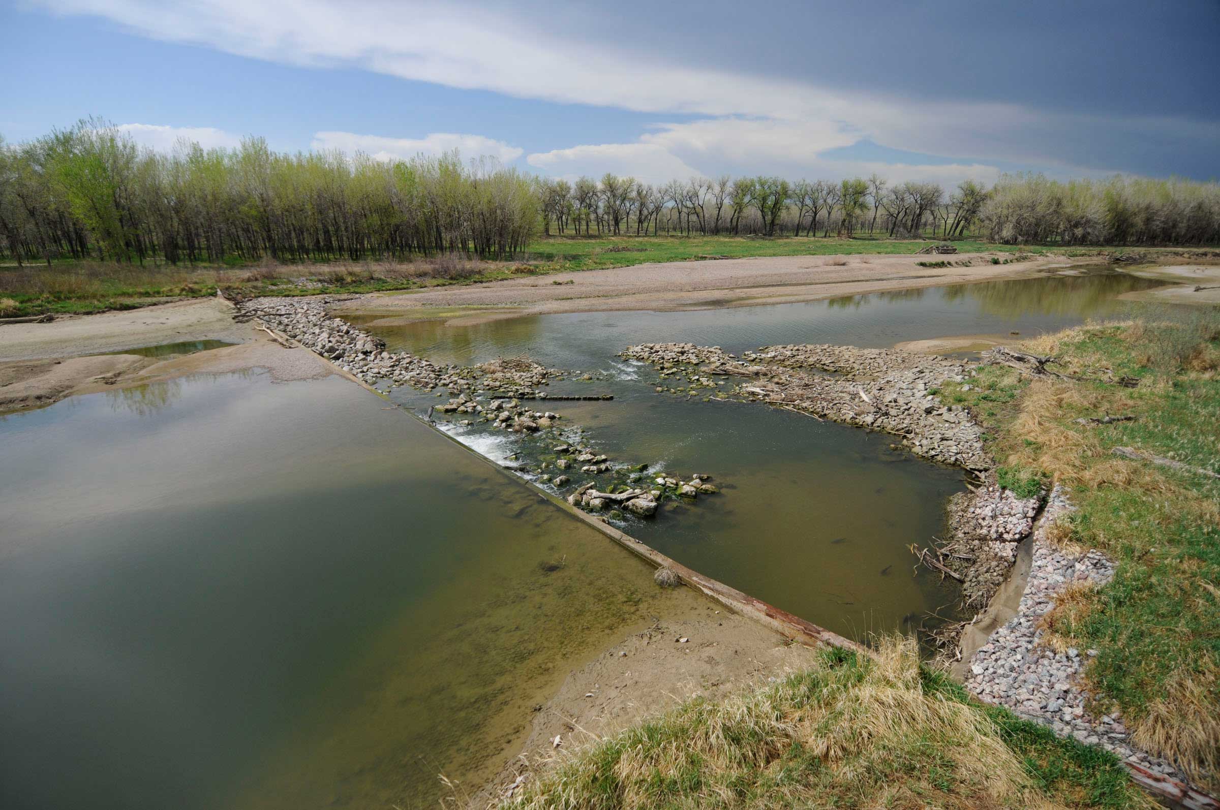 The Stateline Gauge is responsible for monitoring water flows from Wyoming into Nebraska. A litigious past has resulted in settlements on the quantity of water each state receives and what that water is used for, whether it's irrigation, recreation, power generation or wildlife habitat. Looking upstream from the monitoring station, one camera watches the last of the North Platte water as it passes into Nebraska. As a braided river does, the meandering channel is threatening to overtake the south bank, bypassing the weir, where water is measured. Construction to prevent this erosion is scheduled to begin in 2013. A second camera faces downstream, looking at the weir itself.